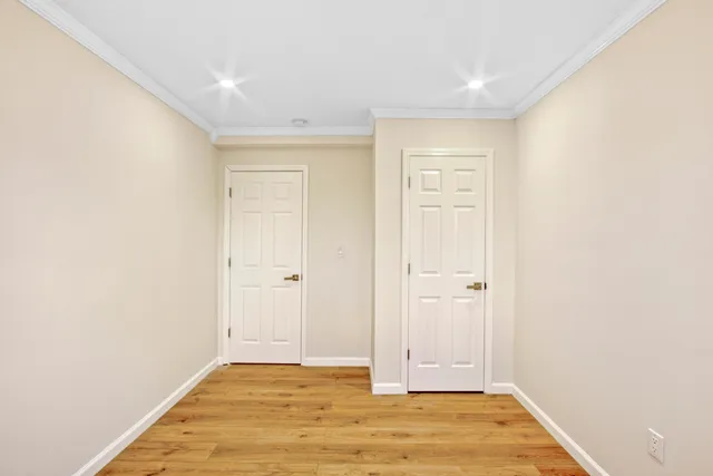 a bedroom with furniture and a large window