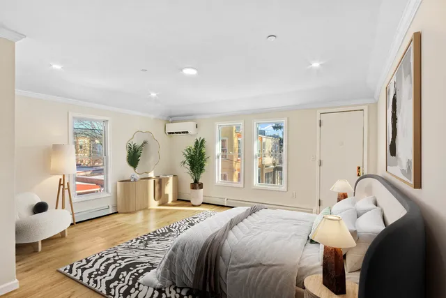 a bedroom with a large bed and a window