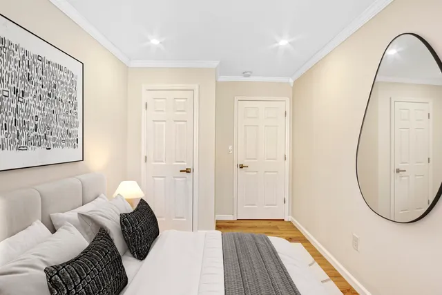 a bedroom with a bed and a mirror