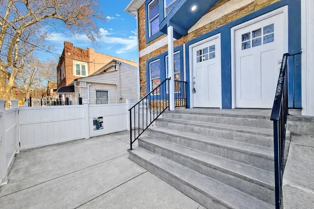 a view of a white house with large windows