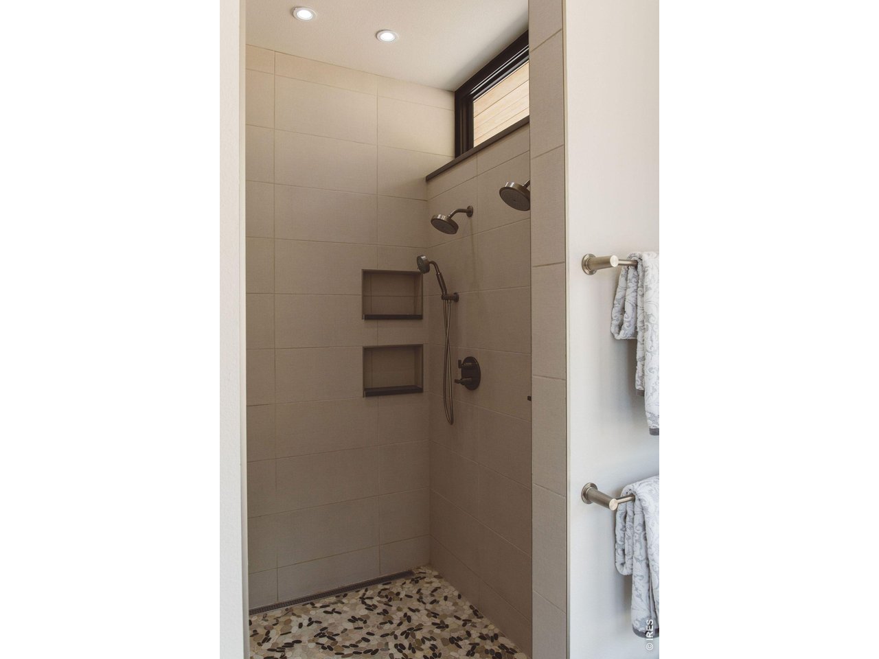 16132 Steller Ridge Road Loveland, CO 80538 - Photo 28 of 50 Double shower heads and custom niches that blend function and design