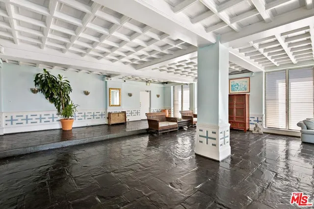 a view of a dining room with furniture and a chandelier
