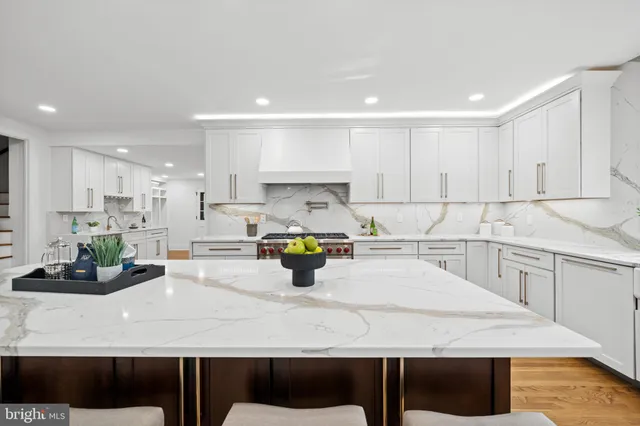 a kitchen with a table chairs sink and cabinets