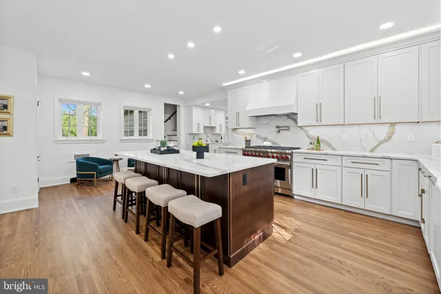 a living room with furniture wooden floor and window