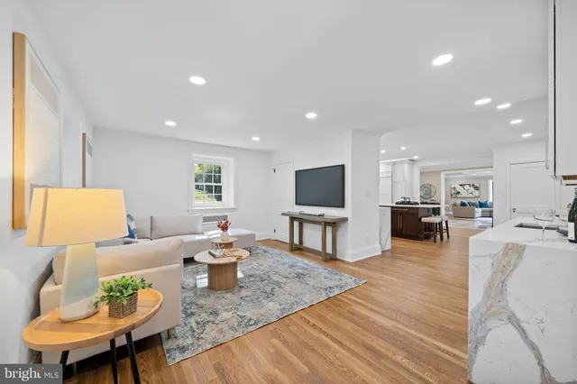 a kitchen with stainless steel appliances granite countertop a sink and cabinets with wooden floor