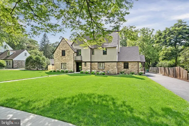 a front view of a house with yard and green space