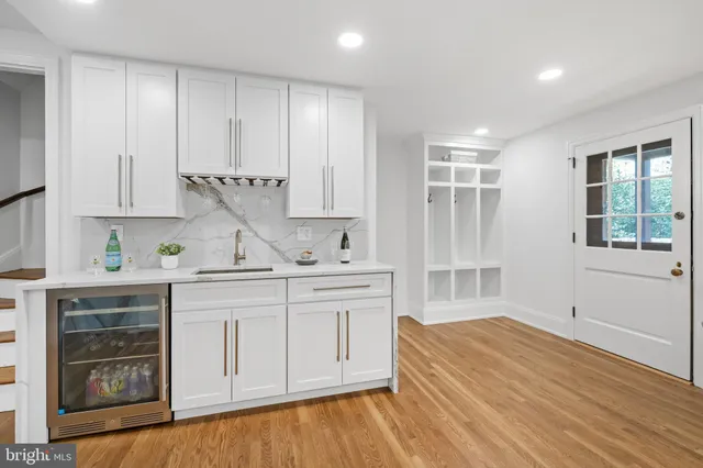 a view of a dining room with furniture a rug and wooden floor
