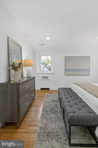wooden floor in an empty room with cabinet and a window