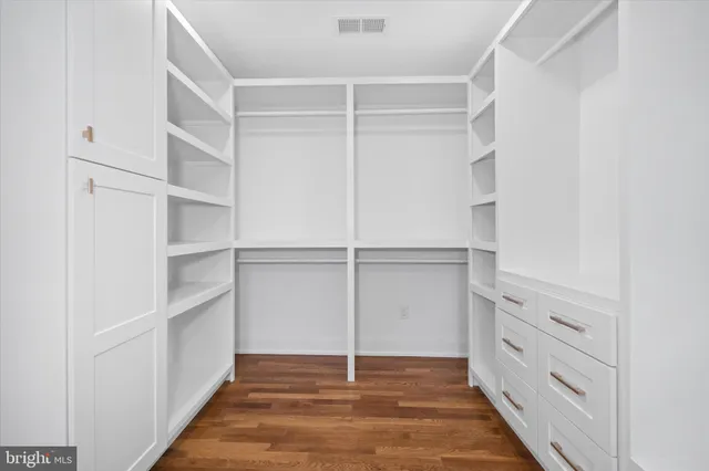 an empty room with a window and a ceiling fan
