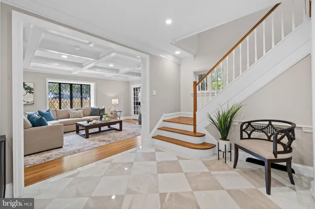 a living room with furniture and stairs