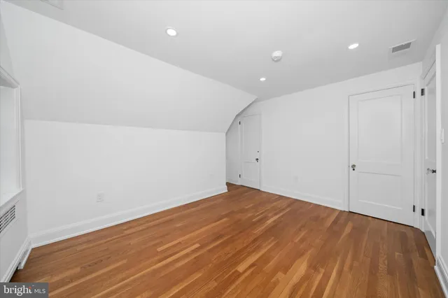 a bathroom with a granite countertop shower sink a toilet and a large mirror