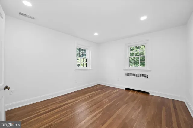a bathroom with a toilet a sink a vanity and mirror