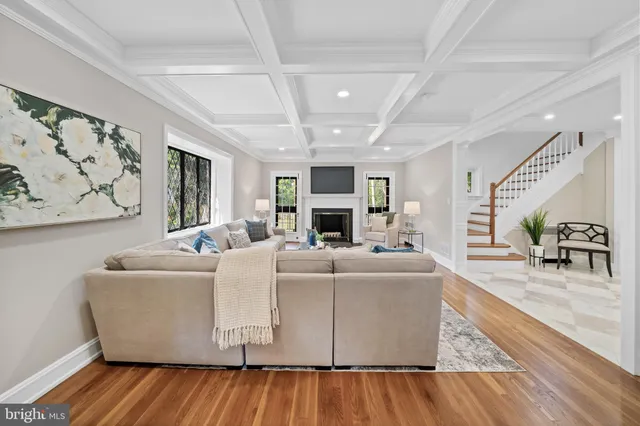 a living room with fireplace furniture and a wooden floor