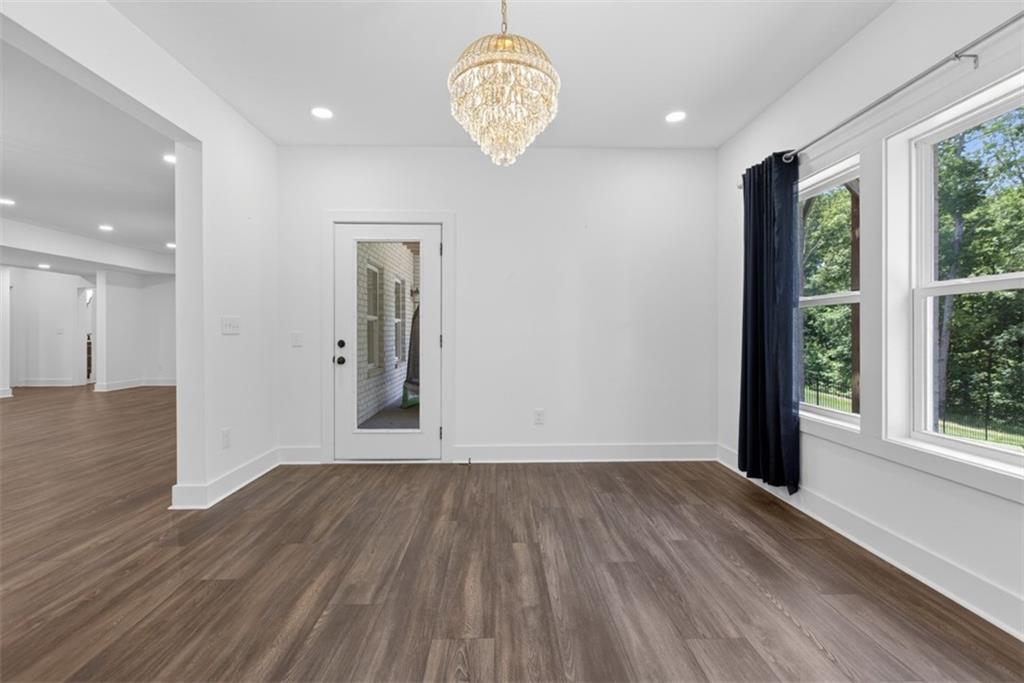 3528 North Bogan Road Buford, GA 30519 - Photo 63 of 79 an empty room with wooden floor and windows