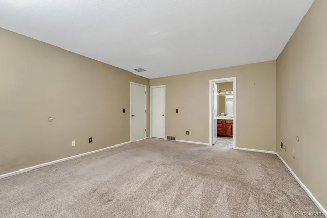 a view of an empty room with closet area