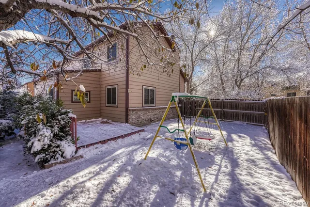 a view of a backyard with wooden fence