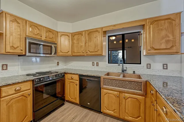 a kitchen with stainless steel appliances granite countertop a sink stove and microwave