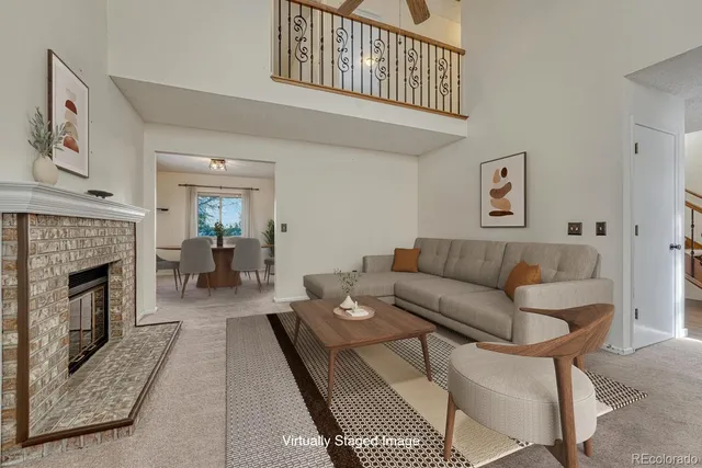 a living room with furniture a fireplace and a table