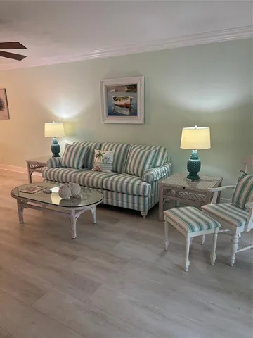 a living room with furniture and a lamp