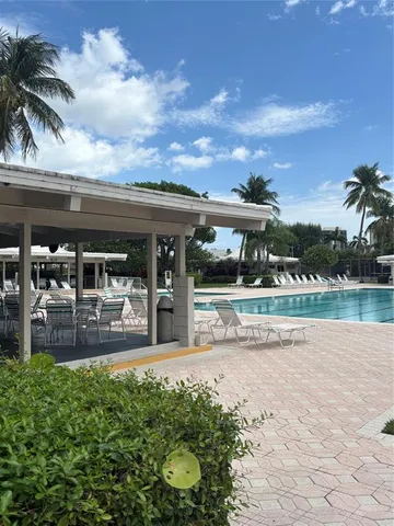 a view of building with swimming pool and outdoor seating
