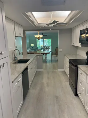 a kitchen with sink cabinets and window