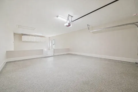 an empty room with shelves and windows