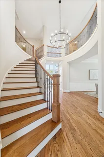 a dining room with wooden floor and white walls