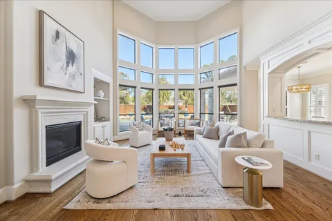 a view of a dining room with furniture a rug and wooden floor