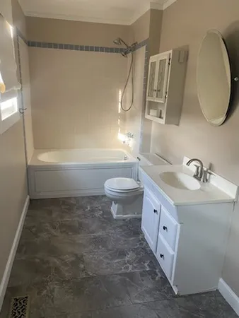 a bathroom with a sink a toilet and a mirror