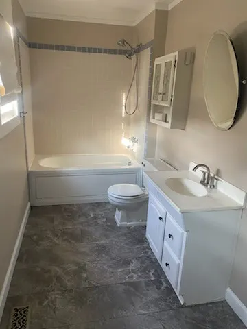 a bathroom with a sink a toilet and a mirror