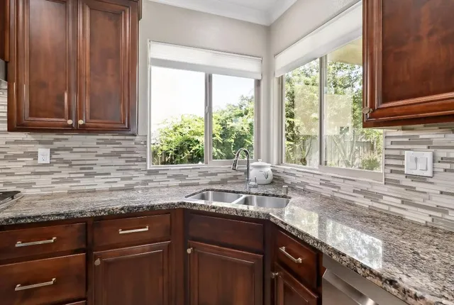 a view of a hallway with wooden floor and windows