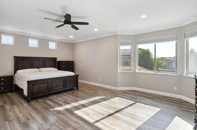 a bedroom with a bed and wooden floor