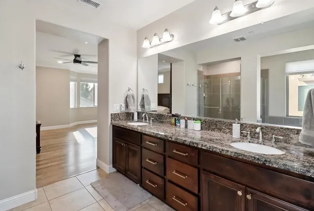 a bathroom with a sink toilet a mirror and shower