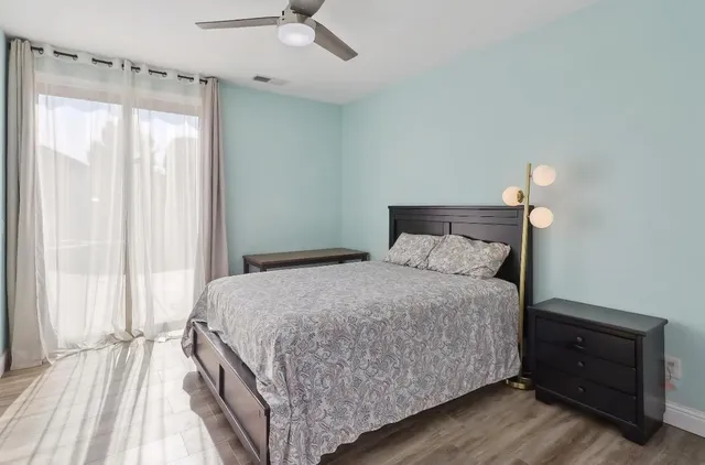 a bedroom with a bed and a chandelier