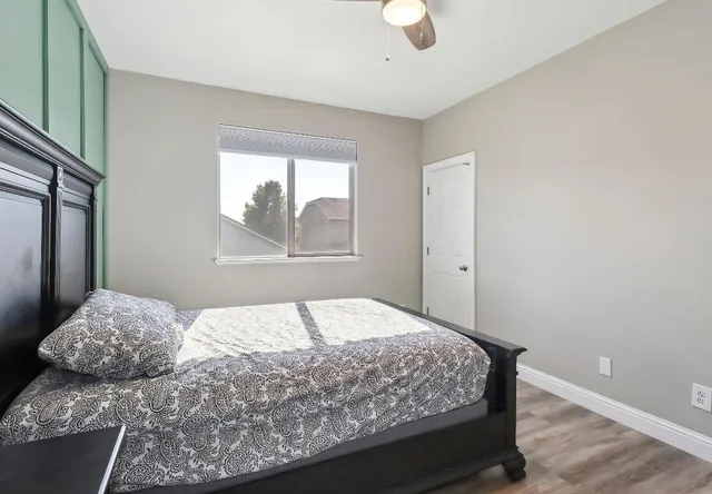 a bedroom with a bed and a window