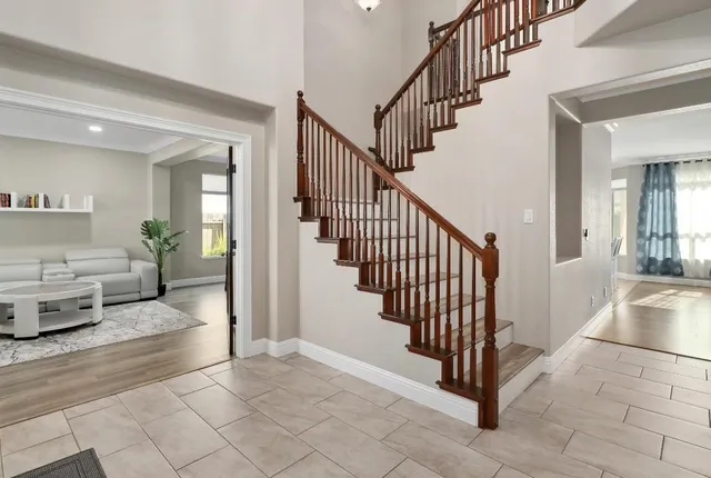 a living room with furniture and a potted plant
