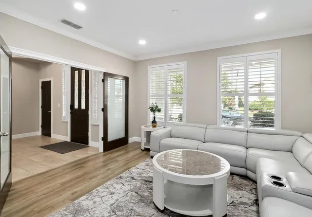 a view of a livingroom with furniture window and wooden floor