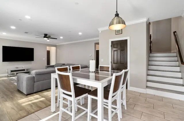 a living room with furniture and kitchen view