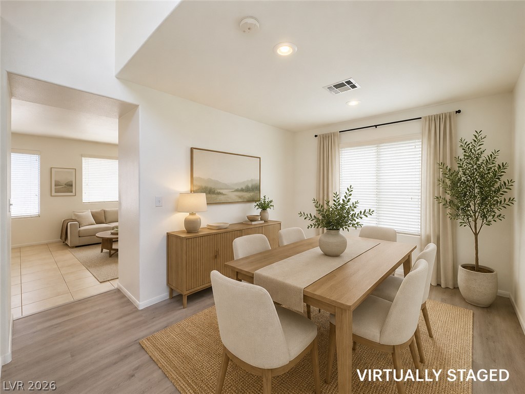 9456 Grandview Spring Avenue Las Vegas, NV 89166 - Photo 6 of 49 Virtually Staged. A refined dining space with warm wood flooring and abundant natural light creates an inviting atmosphere.