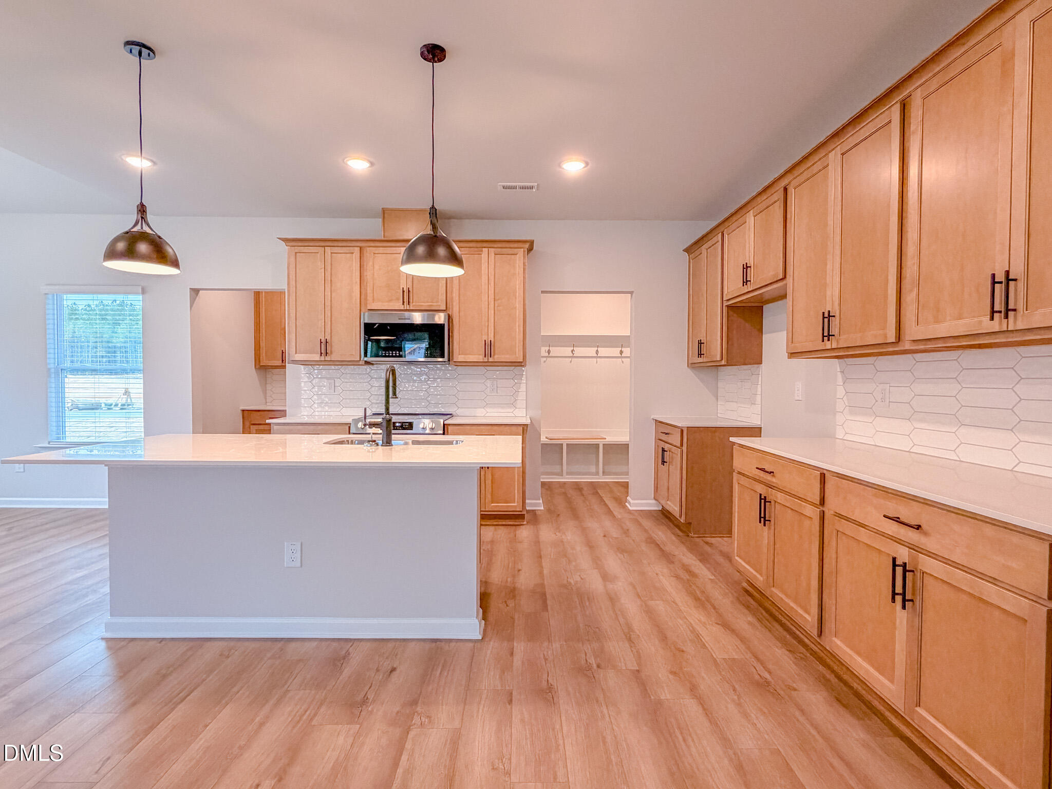 460 Beacon Hl Road Lillington, NC 27546 - Photo 13 of 48 a large kitchen with kitchen island granite countertop a stove a sink a center island and wooden floor