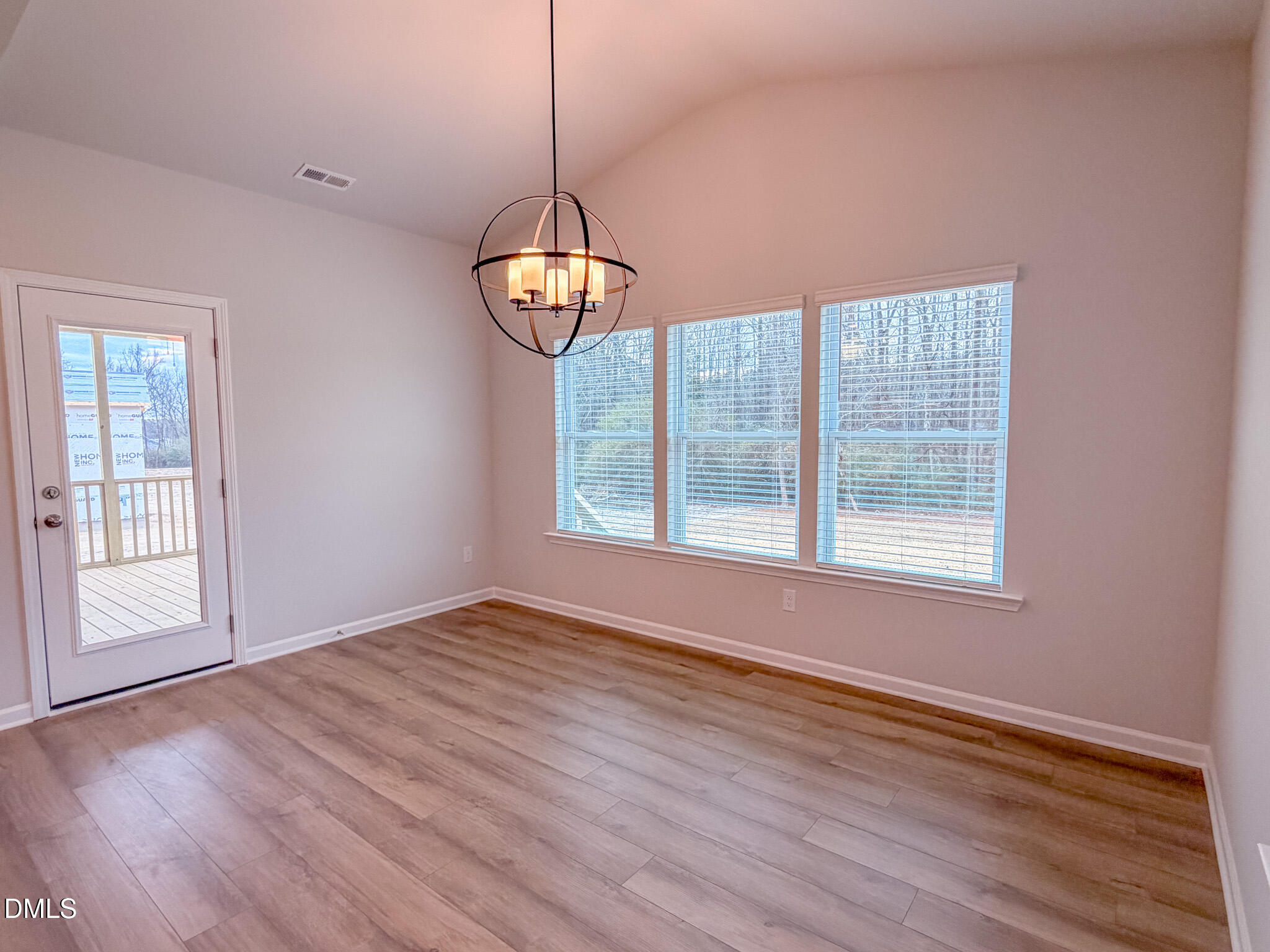 460 Beacon Hl Road Lillington, NC 27546 - Photo 20 of 48 a view of an empty room with wooden floor and a window