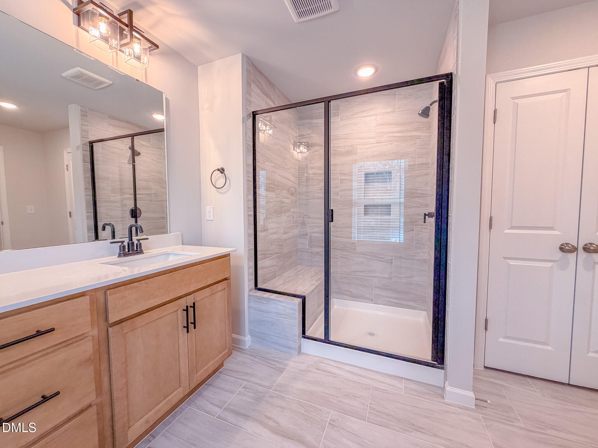 460 Beacon Hl Road Lillington, NC 27546 - Photo 33 of 48 a bathroom with a double vanity sink a mirror and a shower