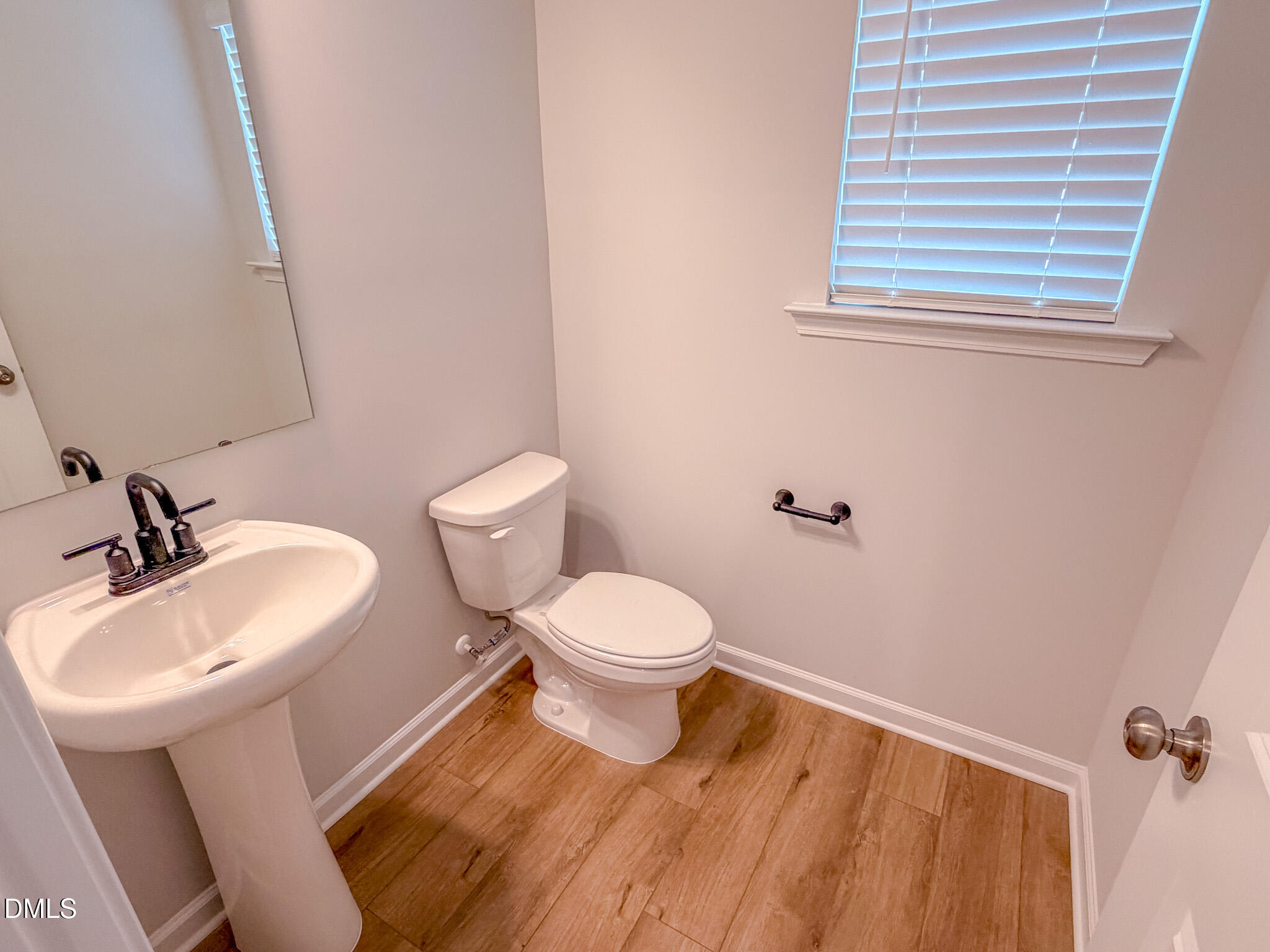 460 Beacon Hl Road Lillington, NC 27546 - Photo 9 of 48 a bathroom with a toilet a sink and mirror