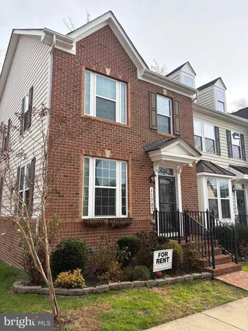 a front view of a house with a yard and a fountain