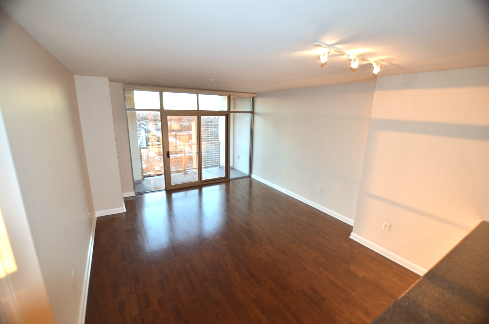 1235 South Prairie Avenue, Unit 3206 Chicago, IL 60605 - Photo 9 of 46 a view of an empty room with wooden floor and a window