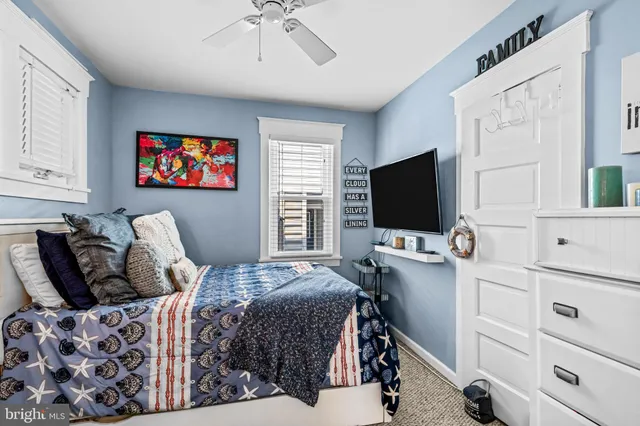 a bedroom with bed tv and window