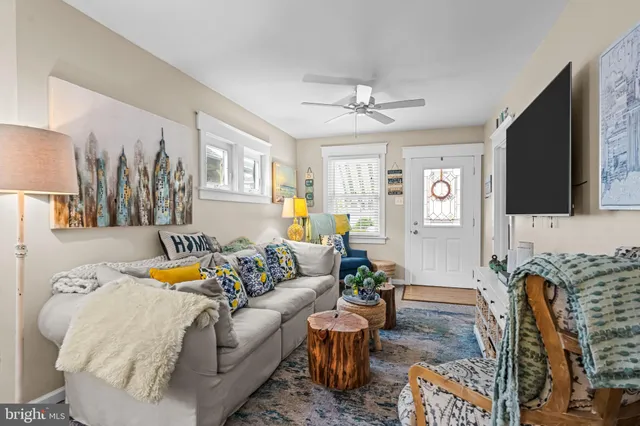 a living room with patio furniture and a flat screen tv