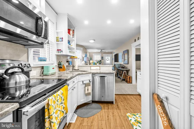 a kitchen with stainless steel appliances granite countertop a sink and cabinets
