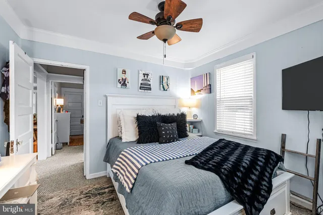 a bedroom with a large bed and a flat screen tv