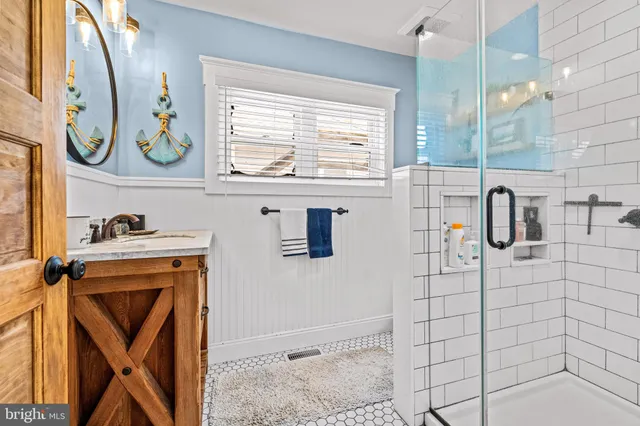 a bathroom with a sink a mirror and shower